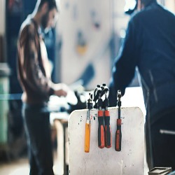 Technician repairing an angle grinder at Delhi Power Tools
